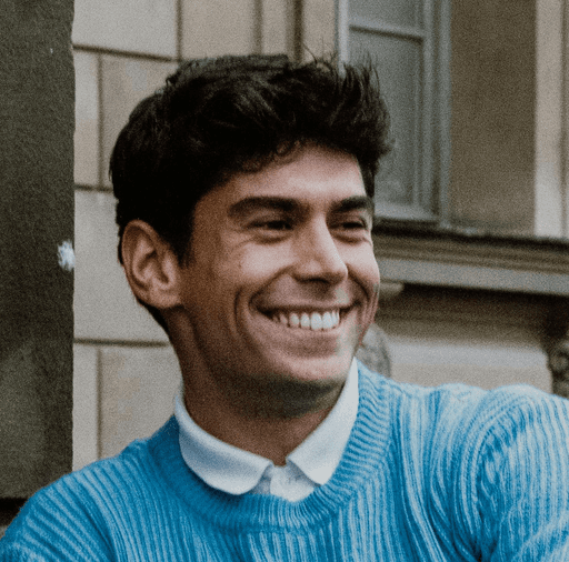 A man standing in front of a window smiling